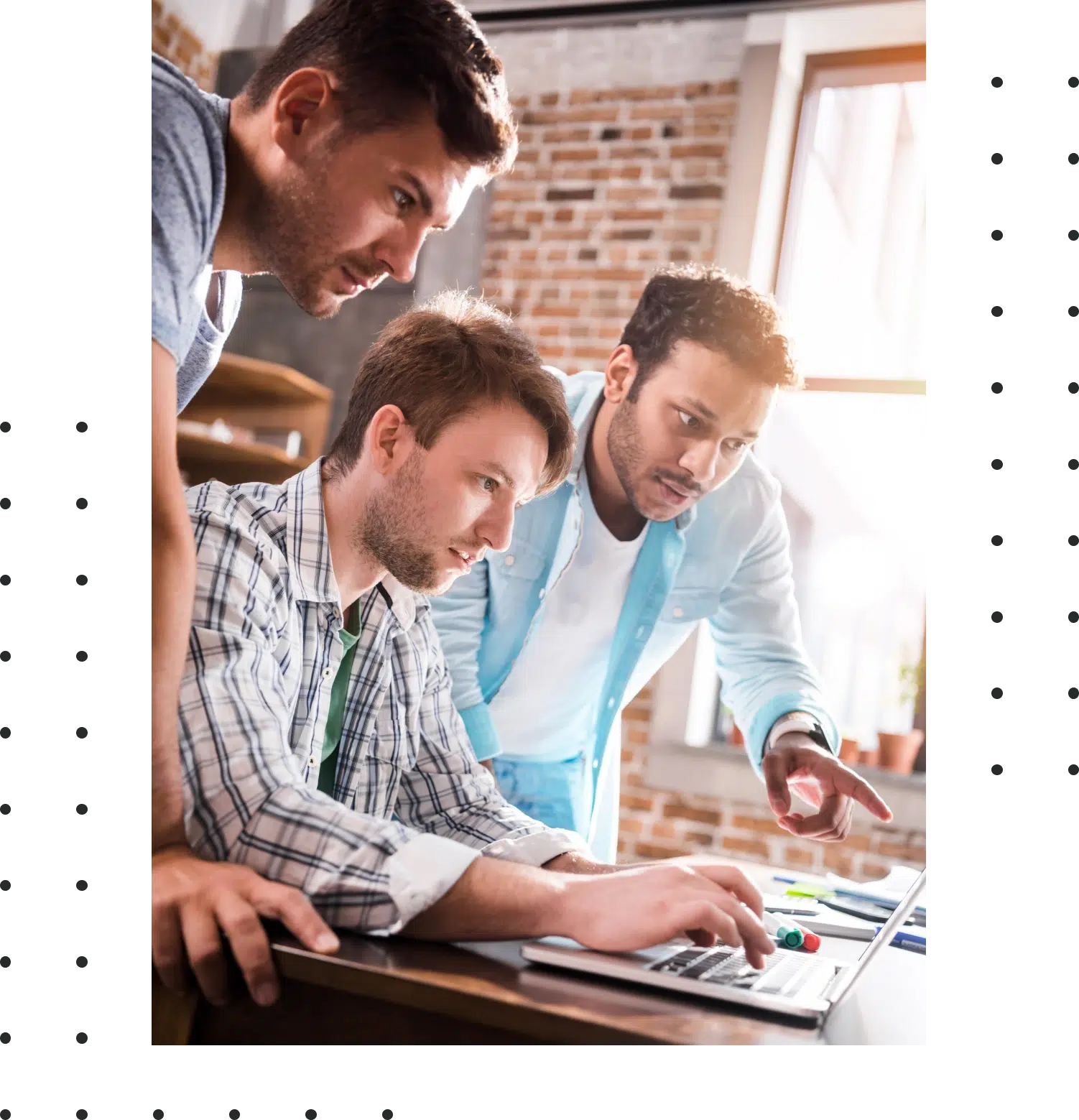 young professional group using laptop and discussing